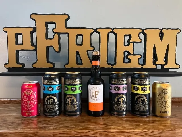 A lineup of pFriem bottles and cans on the bar