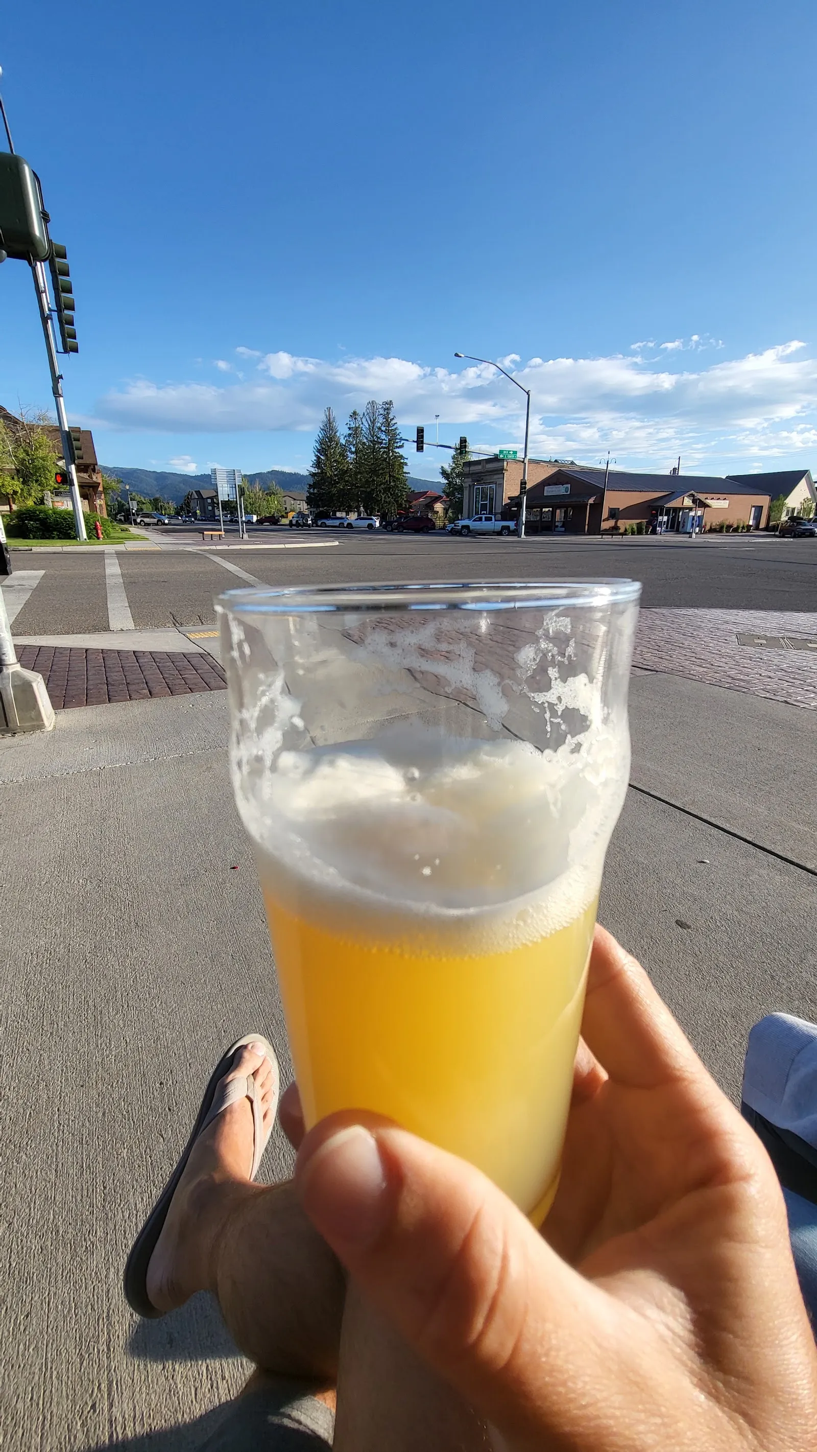 A pint held up on the sidewalk on Main Street in Victor